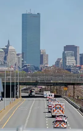  ?? STUART CAHILL / HERALD STAFF ?? HONORS: A parade of more than 40 EMS vehicles heads down the Pike into Boston on Wednesday. EMTs arrived at Fenway Park, left, for an event, upper left, to mark National EMS Week.