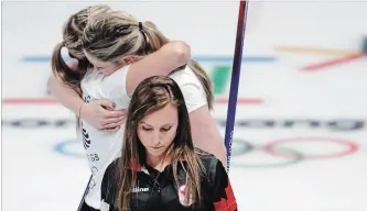  ?? ASSOCIATED PRESS FILE PHOTO ?? Canada’s skip Rachel Homan, centre, leaves the ice as Britain’s Lauren Gray and Vicki Adams embrace after winning a women’s curling match at the 2018 Winter Olympics in Gangneung, South Korea, in February.