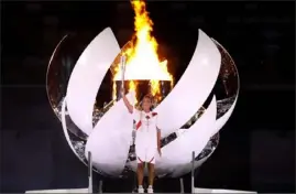  ?? Getty Images ?? Naomi Osaka of Team Japan lights the Olympic cauldron Friday during the opening ceremonies of the Tokyo 2020 Olympic Games.