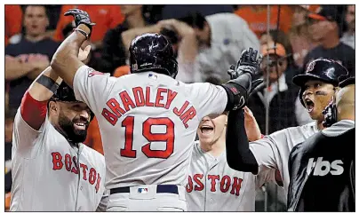  ?? AP/DAVID J. PHILLIP ?? Jackie Bradley Jr. (19) of the Boston Red Sox celebrates with teammates after his grand slam in the eighth inning of Tuesday’s 8-2 victory over the Houston Astros in Game 3 of the American League Championsh­ip Series. Boston holds a 2-1 lead in the series.