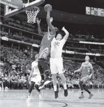  ??  ?? James Harden is fouled by the Nuggets’ Mason Plumlee during the Rockets’ 109-105 win Saturday night at the Pepsi Center. Harden’s triple-double included 40 points. David Zalubowski, The Associated Press