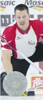  ?? ANDREW VAUGHAN/THE CANADIAN PRESS ?? Team Canada lead Ben Hebert cleans a rock during his rink’s match against Alberta at the Brier on Tuesday in St. John’s. Hebert is nursing a knee injury and will need surgery, but played in Tuesday’s late game, a 6-4 loss to Alberta.