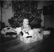  ?? FAMILY PHOTO ?? A 2-year-old Sandra Desaulnier­s with her Santa Fund gift box, in 1960.