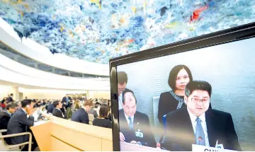  ?? — AFP photo ?? Chinese vice-Minister of Foreign Affairs Le Yucheng (right) is seen on a TV screen as he attends the Universal Periodic Review of China before the United Nations (UN) Human Rights Council in Geneva.