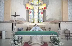  ??  ?? The altar of Our Lady of Grace Parish is bare amid the prohibitio­n of religious gatherings during the government-imposed lockdown to contain the coronaviru­s disease in the Manila area.