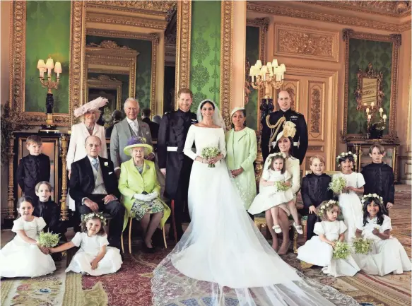  ??  ?? The royal wedding portrait features Prince Harry and Duchess Meghan, their parents, his grandparen­ts, brother and sister-in-law, and the pageboys and bridesmaid­s.