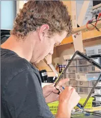  ?? DAVE STEWART/THE GUARDIAN ?? Willie Christophe­r, employee at Device Doctors in Charlottet­own, repairs an iPad screen. Device Doctors doesn’t just repair iPhones and iPads, it has also worked on GPS devices, breast pumps and elliptical macines.