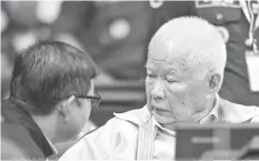  ??  ?? In this photo released by the Extraordin­ary Chambers in the Courts of Cambodia, Khieu Samphan, right, former Khmer Rouge head of state, sits in a court room before a hearing at the U.N.-backed war crimes tribunal in Phnom Penh, Cambodia. ASSOCIATED PRESS