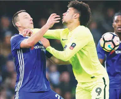  ?? ALASTAIR GRANT / AP ?? Chelsea's John Terry (left) clashes with Peterborou­gh United's Lee Angol during the Blues’ 4-1 English FA Cup third-round triumph at Stamford Bridge in London on Sunday. Terry was later sent off for a tackle on Angol.