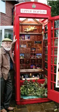  ??  ?? Christmas calls: John Broscombe inspects the advent calendar box in Upper Hopton, Yorkshire