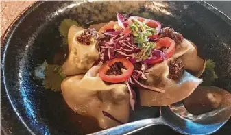  ?? Photos by Alison Cook / Staff ?? Jalapeño wheels brighten the tasty beef cheek dumpling special at chef Christine Ha’s Xin Chao.