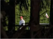  ?? GREG LOVETT — THE PALM BEACH POST VIA THE ASSOCIATED PRESS ?? President Trump plays golf Monday at the Trump Internatio­nal Golf Club in West Palm Beach, Fla.