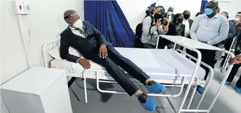  ?? Picture: Sandile Ndlovu ?? Health minister Zweli Mkhize tests a mattress in one of the newly built Covid-19 wards at Clairwood Hospital in Durban. Mkhize visited urban and rural hospitals in KwaZulu-Natal to check the state of readiness as the pandemic approaches its expected peak in the province.