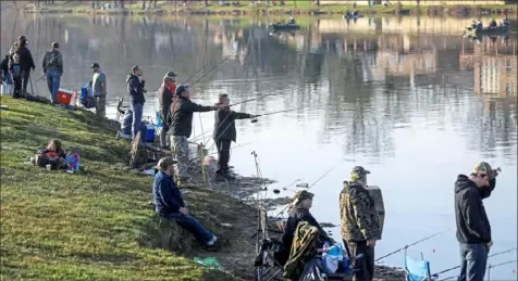  ?? Jessie Wardarski/Post-Gazette ?? Close quarters “combat fishing,” as shown in this 2018 photo at Canonsburg Lake on the opening day of trout season, is impactical during the spread of COVID-19.