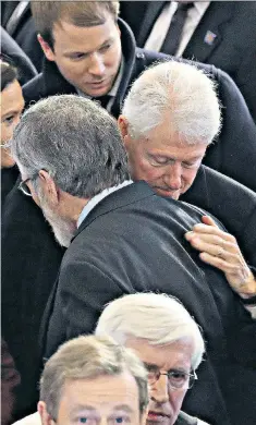  ??  ?? Embracing: Bill Clinton and Gerry Adams after the funeral of Martin McGuinness