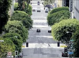  ?? Kent Nishimura Los Angeles Times ?? GRAND AVENUE is nearly empty on Tuesday. Gov. Gavin Newsom maintains that the vast majority of California­ns are abiding by the stay-at-home restrictio­ns