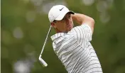  ?? SUE OGROCKI / AP* ?? Rory McIlroy watches his tee shot during a practice round in Tulsa, Okla. The 2014 PGA Championsh­ip winner is looking for his fifth major title.