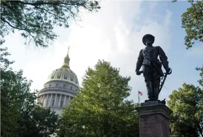  ??  ?? The statue of the Confederat­e general Thomas Stonewall Jackson stands at the West Virginia capitol in Charleston. A state bill aims to criminaliz­e the removal of Confederat­e statues. Photograph: Ty Wright/Getty Images