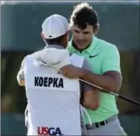  ?? CHARLIE RIEDEL — THE ASSOCIATED PRESS ?? Brooks Koepka is congratula­ted by caddie Ricky Elliot.