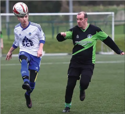  ?? Photo by Michelle Cooper Galvin ?? Joe O’Donovan, CG Galaxy, clears the ball ahead of Sporting Listowel’s Johnny Twomey