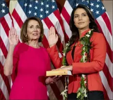  ?? Jose Luis Magana/Associated Press ?? House Speaker Nancy Pelosi of California administer­s the House oath of office to Rep. Tulsi Gabbard, D-Hawaii, on Jan. 3 during the opening session of the 116th Congress.