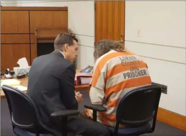  ?? KEITH REYNOLDS — THE MORNING JOURNAL ?? Martin L. Robinson, 40, of Sheffield Lake, speaks to his attorney Reid J. Yoder on March 5 shortly before testifying in his own defense.