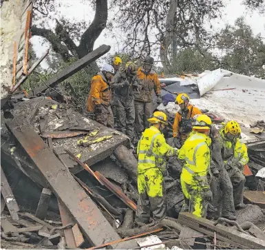  ?? Mike Eliason / Santa Barbara County Fire Department ?? Firefighte­rs rescue a 14-year-old girl (right) who was trapped for hours inside a home in Montecito that was destroyed by mudslides caused by heavy rains in fire-ravaged Santa Barbara County where 13 people died.