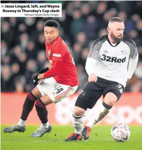  ?? Michael Regan/Getty Images ?? > Jesse Lingard, left, and Wayne Rooney in Thursday’s Cup clash