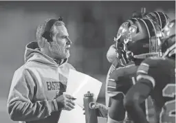  ?? CARLOS OSORIO/AP FILE ?? Eastern Michigan head coach Chris Creighton talks to his team during the second half against Western Michigan on Nov. 16 in Ypsilanti, Mich. Eastern Michigan has been to four bowl games in the past five years under coach Creighton but won its only title in 1987.