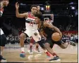  ?? NICK WASS — THE ASSOCIATED PRESS ?? Collin Sexton drives against Wizards guard Jerome Robinson during Feb. 21 in Washington.