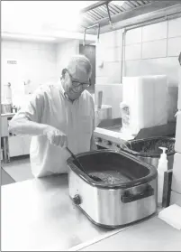  ?? Katie West • Times-Herald ?? The Soup Kitchen at Graham Memorial Presbyteri­an Church in Forrest City is open each Monday,from 11 a.m. to 1 p.m., offering a meal for those in need. Volunteer Bill Swearengin stirs a pot of green beans to keep them ready for serving.