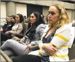  ?? KATHLEEN RONAYNE — THE ASSOCIATED PRESS ?? Renee Wetzel, right, whose husband died in the 2015 San Bernardino terrorist attack, watches as fellow family members of mass shooting victims call on the state’s public pension fund to stop investing in gun retailers.