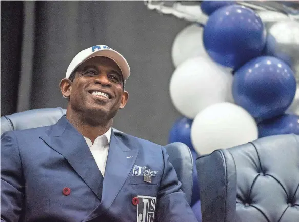  ?? ERIC SHELTON/CLARION LEDGER ?? Deion Sanders listens as Jackson State athletics director Greg Seitz (not shown) speaks during the announceme­nt of Sanders as head coach for the university's football team Monday.