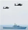  ??  ?? On guard: Singapore’s naval ships and air force helicopter­s patrol Sentosa island