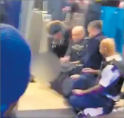  ??  ?? HELD: A video still of officers restrainin­g the alleged knife attack suspect at Ilford Railway Station