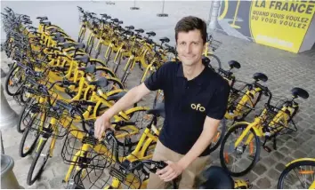  ?? — Reuters ?? Ofo France general manager Laurent Kennel poses with city bike-sharing service Ofo bicycles at Autonomy and the Urban mobility summit in Paris.