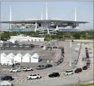  ?? ASSOCIATED PRESS FILE PHOTO ?? Cars line up on March 30at a drive-thru coronaviru­s testing site in front of Hard Rock Stadium in Miami Gardens, Fla. Nobody can say with precise certainty how many coronaviru­s tests that the NBA, NHL and Major League Baseball would need before those leagues can resume playing games.