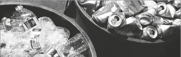  ?? RICH PEDRONCELL­I/AP ?? Cans and plastic bottles brought in for recycling fill containers at a recycling center in Sacramento on July 5, 2016.