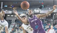  ?? BOB TYMCZYSZYN THE ST. CATHARINES STANDARD ?? St. John Riptide Jeremiah Mordi (23) and Malcolm Miller (33) defend against Niagara River Lions Torrence Dyck (4) Tuesday night .