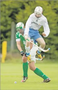  ?? Photograph: Neil Paterson. ?? Skye’s James Pringle takes the high road as he attempts to block Beauly’s Andrew Morrison during last Saturday’s National Division match at Braeview Park which the islanders won 4-2.