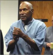  ?? JASON BEAN — THE RENO GAZETTE-JOURNAL VIA AP ?? Former NFL football star O.J. Simpson reacts after learning he was granted parole at Lovelock Correction­al Center in Lovelock, Nev., on Thursday. Simpson was convicted in 2008 of enlisting some men he barely knew, including two who had guns, to...