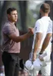  ?? CHRIS PEDOTA — THE RECORD VIA AP ?? Brooks Koepka, left, shakes hands with Dustin Johnson after they completed the second round of the Northern Trust PGA tournament at Ridgewood Country Club in Paramus on Friday.