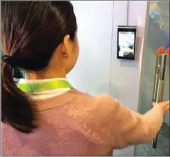  ?? ROBERT LEVER/AFP ?? Ella Yuan of the Chinese startup Tuya shows how facial recognitio­n can be used in a home security system to allow or deny entry.