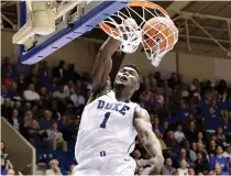  ?? AP Photo/Gerry Broome ?? ■ Duke’s Zion Williamson (1) dunks against Eastern Michigan during the second half Nov. 14 in Durham, N.C. Williamson sure seems comfortabl­e as the star of the show at No. 2 Duke. With his mix of high-flying acrobatics on the court and his charismati­c personalit­y off it, Williamson has emerged as the natural face of the Blue Devils—and as college basketball as a whole.