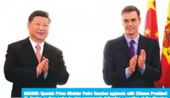  ??  ?? MADRID: Spanish Prime Minister Pedro Sanchez applauds with Chinese President Xi Jinping as they arrive to sign agreements following a meeting at the Moncloa Palace yesterday. — AFP
