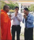  ?? SUPPLIED ?? Two witnesses greet a monk outside Banteay Meanchey Provincial Court yesterday.