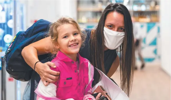  ?? Picture: Emily Barker ?? Shannon Phippen is reunited with daughter Maddyson Langley at Cairns Airport.