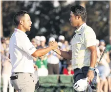  ?? AFP ?? Matsuyama, right, is congratula­ted by Xander Schauffele.