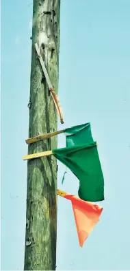  ?? FILE ?? Flags meant to show support to both the Jamaica Labour Party and the People’s National Party on a utility pole at Walks Road, Spanish Town, St Catherine, in 2015.