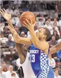 ?? JIM LYTLE/ASSOCIATED PRESS ?? Kentucky guard Isaiah Briscoe (13) shoots a layup around Mississipp­i State guard Mario Kegler (4) during Tuesday’s game.